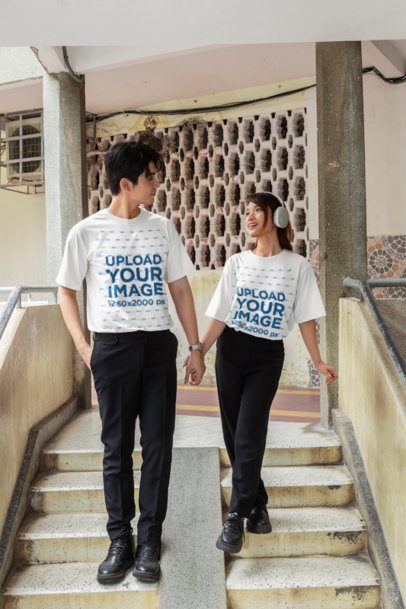 T Shirt Mockup featuring a K-Drama Style Couple Holding Hands on an Outdoor Staircase