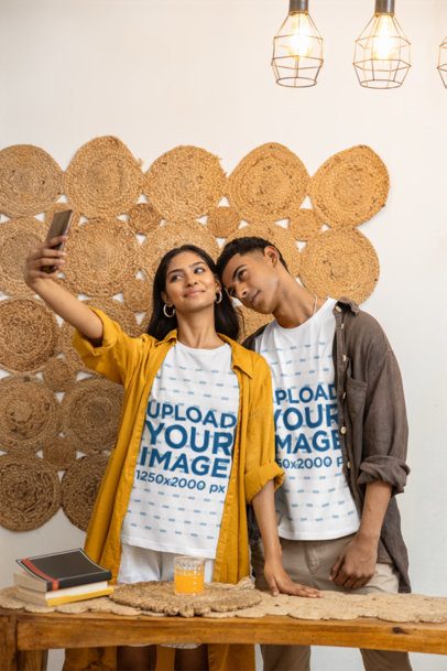 Gen Z Couple T-Shirt Mockup of a Man and Woman posing together at a Wooden Table m55409