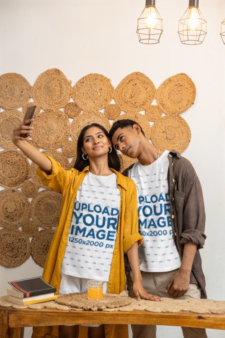 Gen Z Couple T-Shirt Mockup of a Man and Woman posing together at a Wooden Table