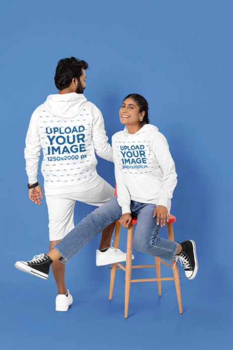 Couple Hoodie Mockup with a Man and a Woman in a Studio Setting