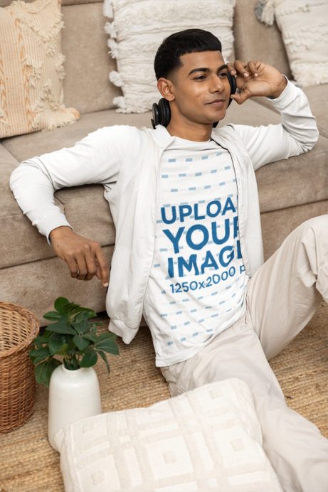 Long Sleeve T-Shirt Mockup Featuring a Young Man Listening to Music Sitting on the Floor