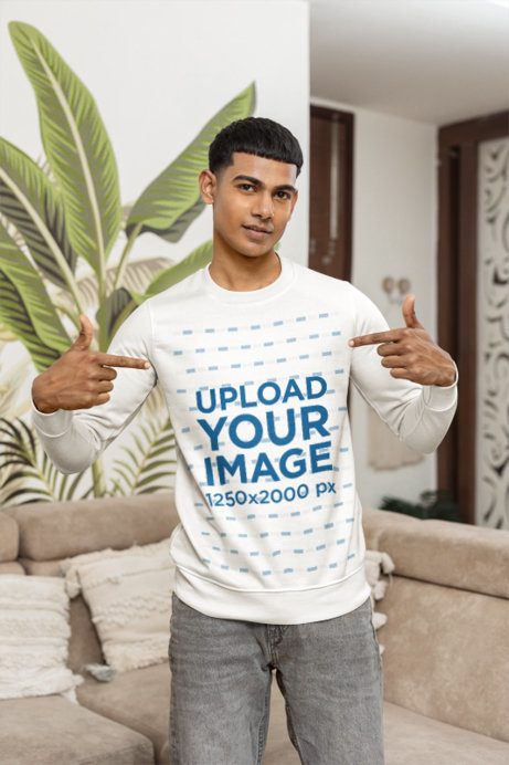 Sweatshirt Mockup of a Man Pointing to Himself in Front of a Couch