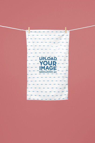 Kitchen Towel Mockup Featuring a Towel Hanging on a Clothesline Against a Solid Background