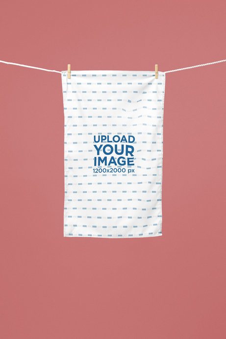 Kitchen Towel Mockup Featuring a Towel Hanging on a Clothesline Against a Solid Background