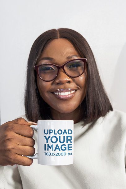 Mug Mockup Featuring a Smiling Black Woman Holding a Mug Against a White Wall m57846