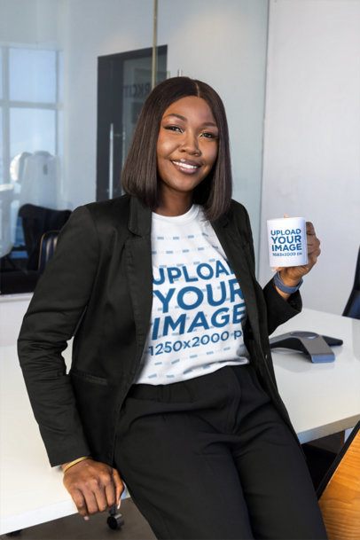 T-Shirt and Mug Mockup Featuring a Smiling Businesswoman Leaning on a White Desk in a Corporate Setting
