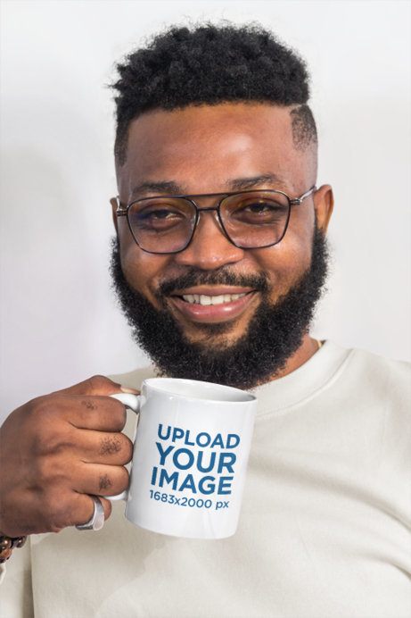 Coffee Mug Mockup Featuring a Smiling Bearded Man Holding a Cup Against a Plain White Background