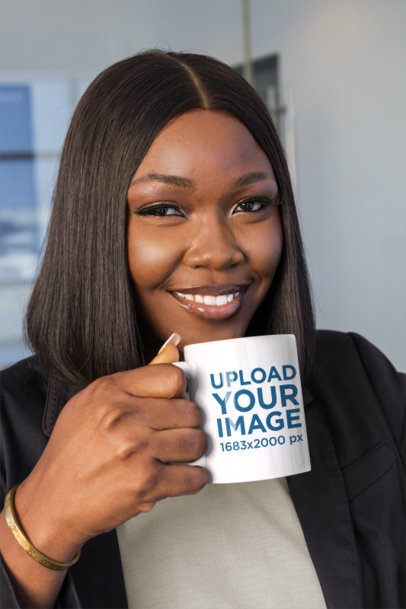 Coffee Mug Mockup Featuring a Smiling Black Businesswoman Holding a Drink in a Corporate Office m57871
