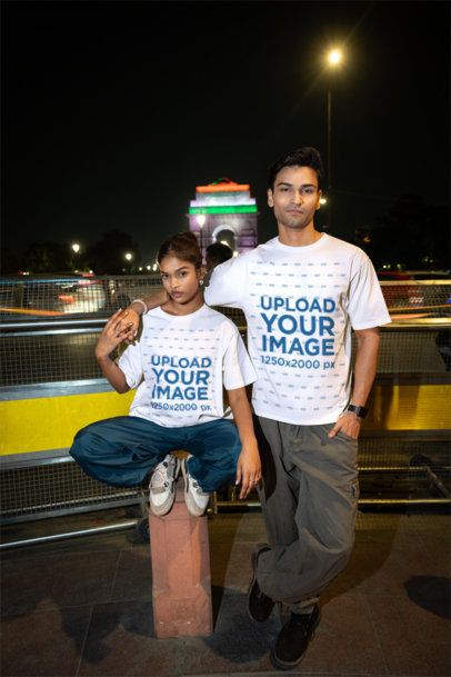 T-Shirt Mockup Featuring a Young Couple Posing Together on an Urban Street at Nigh m56848
