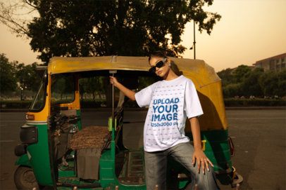T-Shirt Mockup Featuring a Woman in Sunglasses Posing Next to an Auto Rickshaw at Sunset m56811