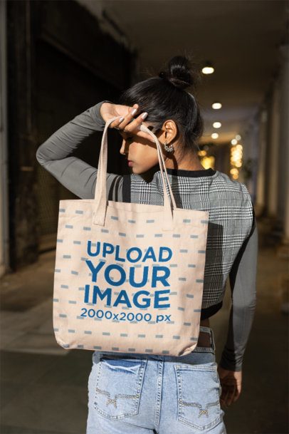 Canvas Bag Mockup of a Stylish Woman Looking Over Her Shoulder in a City Corridor at Night m56892