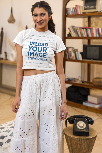 Crop Top Mockup Featuring a Smiling Young Woman Standing in a Cozy Vintage Living Room m57768