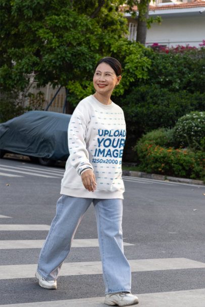 Sweatshirt Mockup Featuring a Smiling Woman Walking Across a Street on a Crosswalk m55956