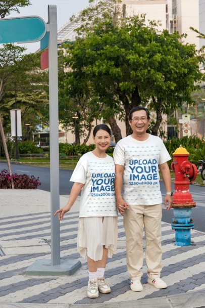 Couples T-Shirt Mockup of a Man and Woman Standing Together Near a Crosswalk m55944