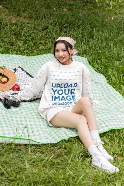 Crewneck Mockup of a Happy Woman Relaxing on a Gingham Mat Outdoors