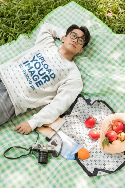 Pullover Mockup With a Young Man Resting on a Gingham Picnic Blanket m57800