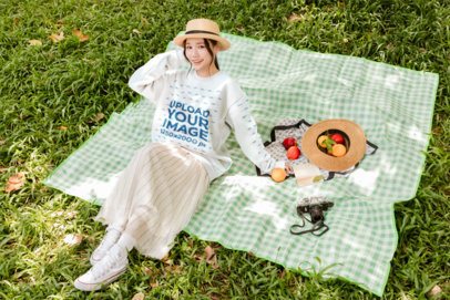 Mockup Of A Pullover With a Young Woman Leaning Back on a Green Gingham Blanket in the Grass m57807