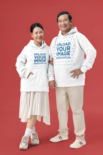 Couples Hoodie Mockup Featuring a Smiling Mature Man and Woman Standing Together Against a Customizable Background