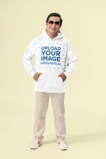 Pullover Hoodie Mockup of a Man Wearing Sunglasses With Hands in His Pockets in a Studio