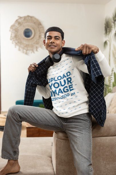 Mens Sweatshirt Mockup Featuring a Smiling Young Man Pointing at the Camera in a Boho Living Room