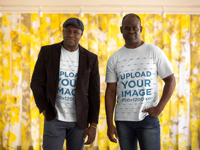 Mockup of Two Brothers Wearing T-Shirts Against Yellow Plastic Curtains