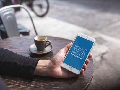 Mockup of an iPhone 8 Plus Being Held at a Coffee Shop 21607