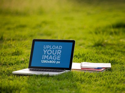 Mockup of a Macbook Pro Lying on the Grass 