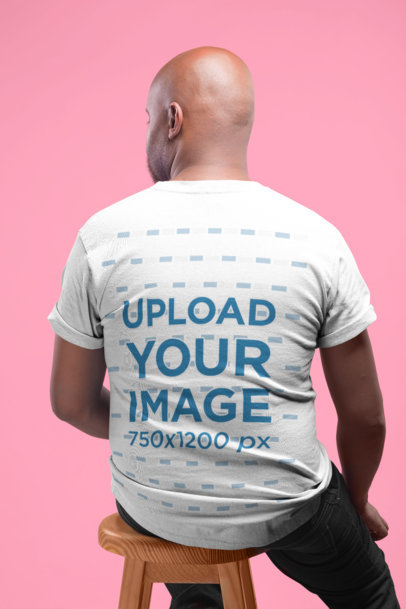 Tshirt Mockup Featuring the Back of a Man Sitting on a Stool