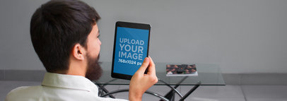 Tablet Mockup of a Man Holding a Black iPad Mini