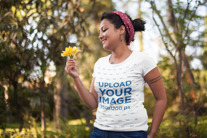 Camping T-Shirt Mockup of a Smiling Woman Holding a Flower