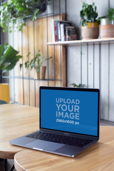 Placeit - Mockup of a MacBook Standing on Wooden Tables Near Books and ...