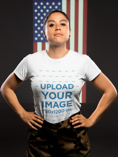 T-Shirt Mockup of a Woman Veteran Standing Against an American Flag