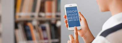 Woman Using her iPhone 6 at the School Library Mockup Template