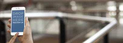 Mockup of a Woman Using Her iPhone 6 At The University Hallway