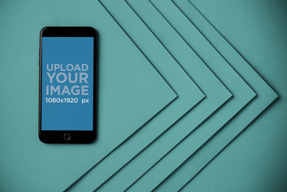Mockup of a Space Gray iPhone Next to a Corner of Pasteboards 21652
