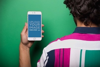 Mockup of a Man Showing an iPhone 8 Plus Wearing a Vintage Shirt