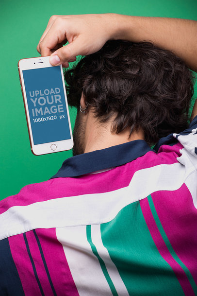 Mockup of a Man Holding an iPhone Over his Head