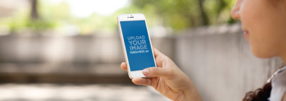 Mockup Template of Woman Holding an iPhone 6 at The Park
