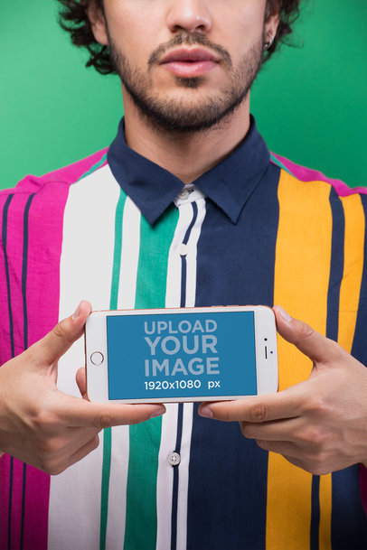 Mockup of a Man Holding an iPhone in Landscape Position
