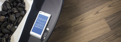 Sony Xperia L Lying On Top of a Black Stone Table Mockup