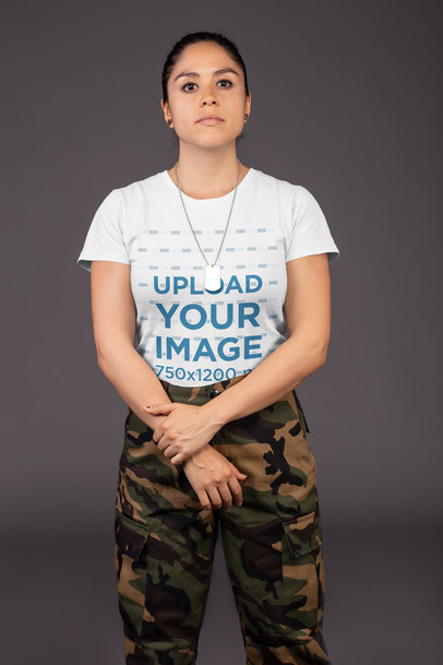 Mockup of a Calm Woman Wearing a T-Shirt and Military Clothing while Holding Her Wrist