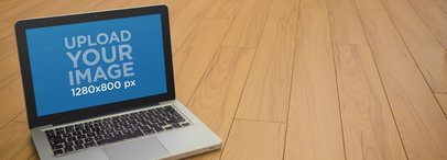 Mockup Template of a Macbook Pro Over Wooden Deck Floor
