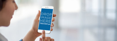 Girl Using an iPhone 6 With Glass Doors Background Mockup