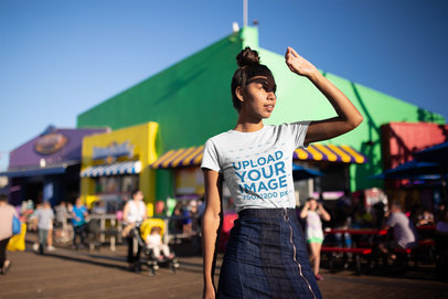 Mockup of a Woman Wearing a T-Shirt by an Amusement Park's Stores