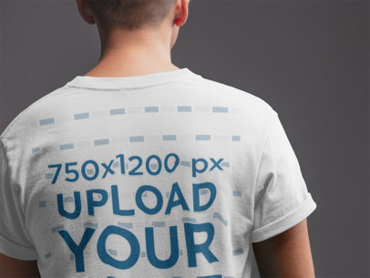 Back Shot T-Shirt Mockup of a Man in a Gray Room