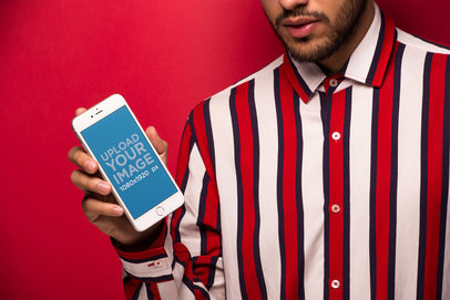 Mockup of an iPhone 8 Plus Being Held in a Red Environment