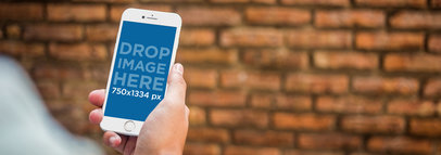 Mockup Template of an iPhone 7 Against a Brick Wall