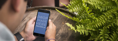 Black iPhone 6 Mockup Featuring a Young Man at a Bar