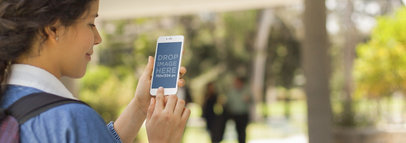 Mockup Template of Young Girl Using White iPhone 6 at School