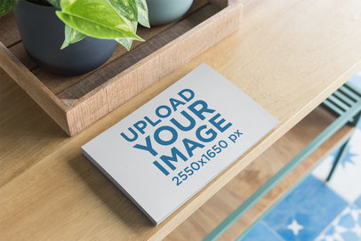 Mockup of a Pile of Horizontal Flyers on a Wooden Table